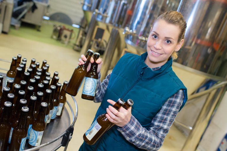 You Brew It, We'll brand It, beer branding agency, female worker in a beer bottleling factory