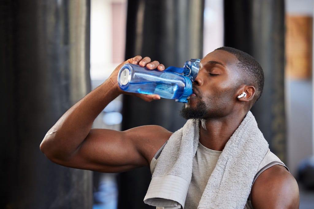 Man drinking water out of a bottle